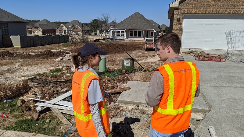 Two experts investigating the construction site and performing environmental inspection.