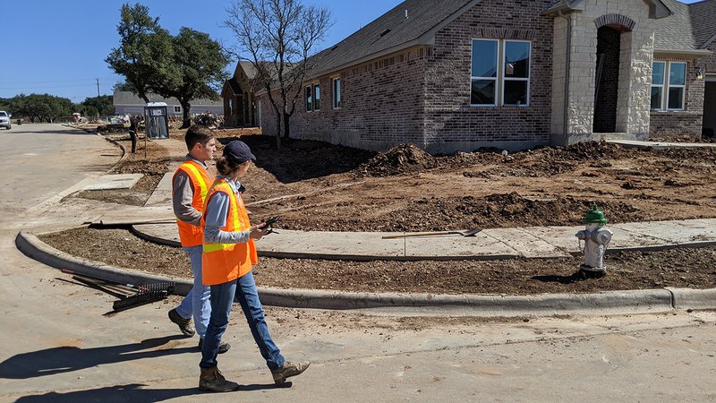 Professionals on a construction site planning an SWPPP training to ease the construction process.