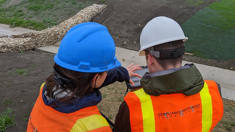 An image of expert professionals planning a stormwater management plan; water storage can be seen.
