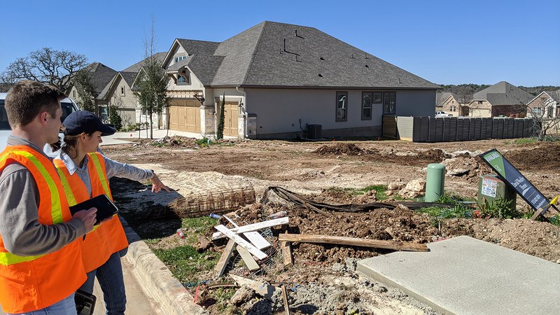 Construction site with machinery; an expert inspector from the best environmental consulting firms.