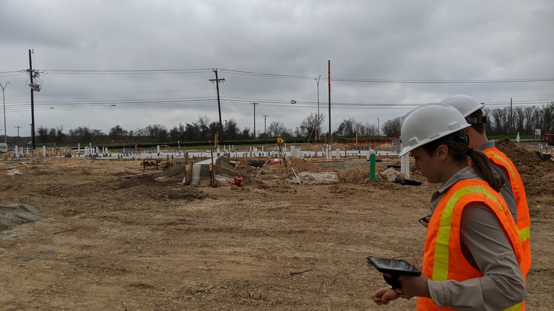 Soil with construction material, our expert is implementing an erosion and sediment control plan.